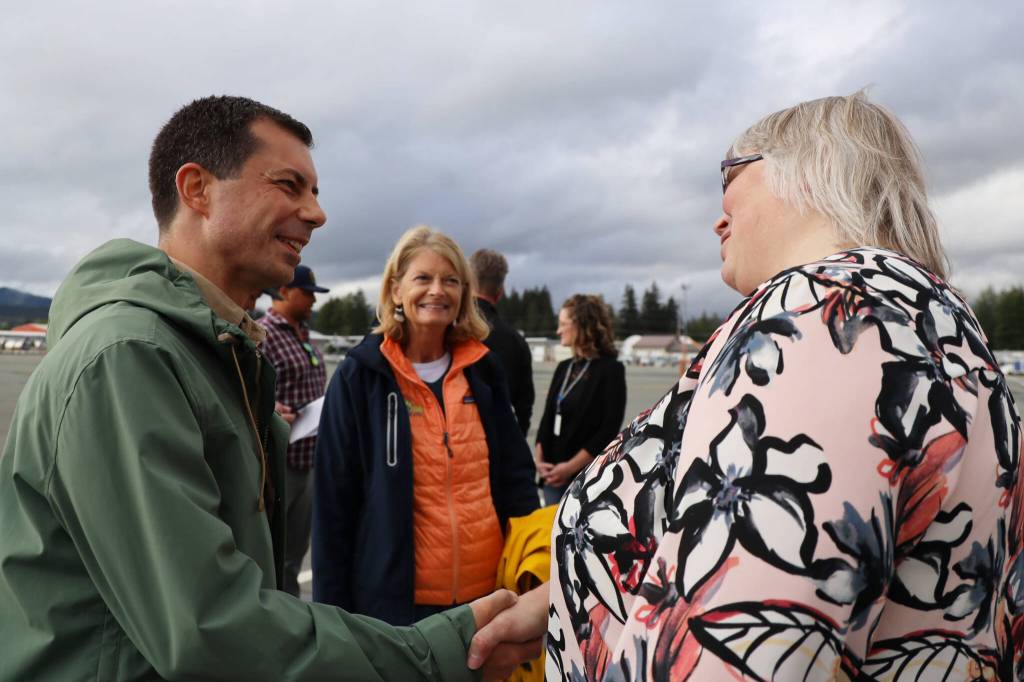 U.S. Transportation Secretary Pete Buttigieg, left, shakes hands with City and Borough of Juneau Mayor Beth Weldon, right, as U.S. Sen. Lisa Murkowski, R-Alaska, smiles at the interaction. The capital city was the final stop on Buttigiegs three-day visit to Alaska. (Clarise Larson / Juneau Empire)