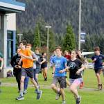 The Thunder Mountain High School cross-country team begin their workout during practice outside of the high school Thursday evening. (Clarise Larson / Juneau Empire)