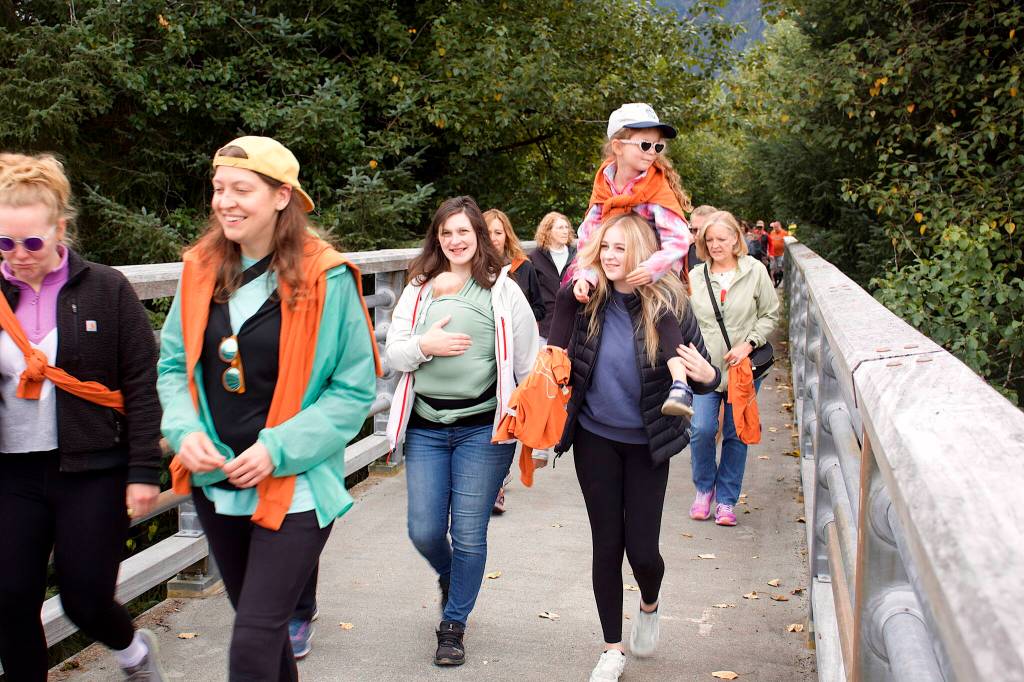 Participants cross a bridge during the walking portion of the 32nd Annual Beat the Odds: A Race Against Cancer on Saturday. (Mark Sabbatini / Juneau Empire)