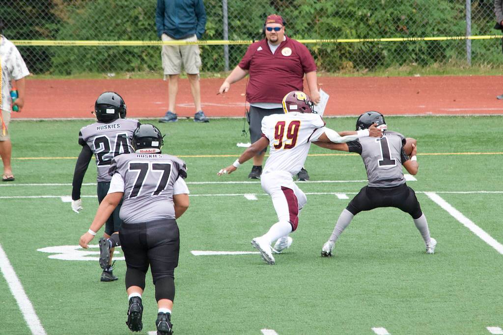 Juneau sophomore quarterback Noah Ault is sacked during the second half of Saturdays game against the Dimond High School Lynx at Adair-Kennedy Field. (Mark Sabbatini / Juneau Empire)