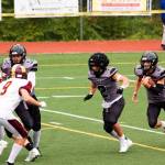 Jayden Johnson (4) looks for running room behind Hayden Aube (2) in the second quarter in the Juneau Huskies game against the Dimond High School Lynx on Saturday at Adair-Kennedy Field. Johnson had 286 all-purpose yards and four touchdowns for the Huskies. (Mark Sabbatini / Juneau Empire)