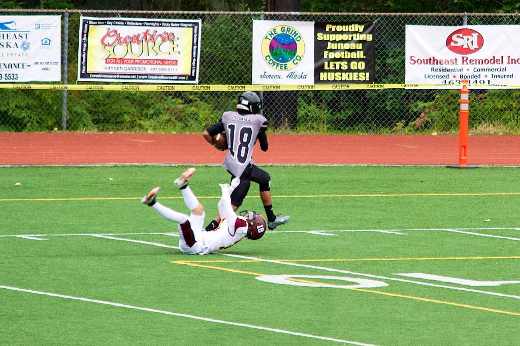 Kenyon Jordan (18) breaks away from a Dimond High School defender to score on a 71-year reception in the third quarter at Adair-Kennedy Field on Saturday afternoon. (Mark Sabbatini / Juneau Empire)