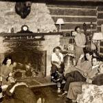 A group of people gather in front of the stone fireplace at Taku Lodge including Leigh Hackley Hack Smith, who inherited one-quarter of the estate from his grandparents at age nine, his mother Erie Smith next to fireplace on the right and Mary Joyce who took over the lodge when Hack died in 1934. (Courtesy of Ken and Mic Ward)