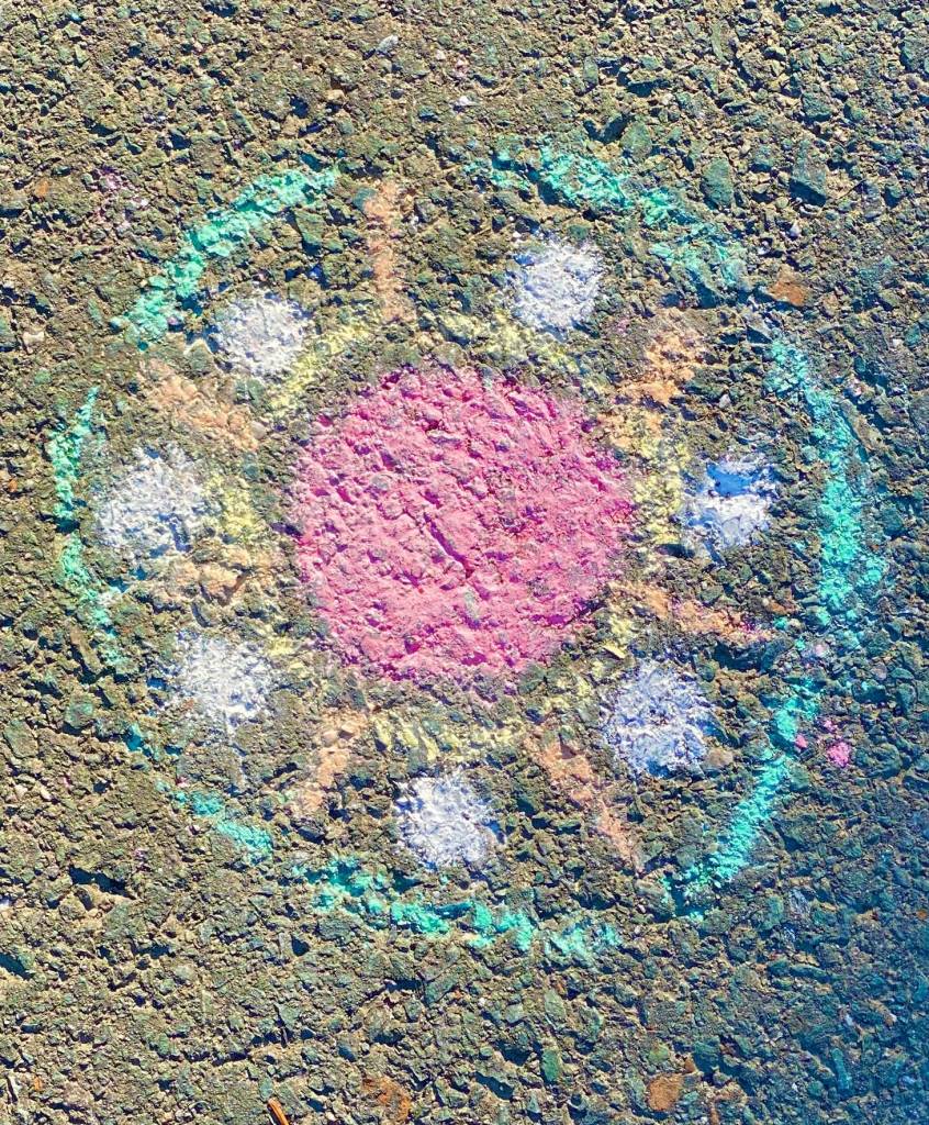 Colorful chalk wheel in a downtown driveway on Aug. 28. (Photo by Denise Carroll)