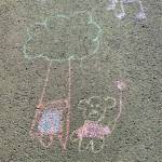 Happy days are here again as depicted in a sidewalk chalk drawing in a downtown driveway on Aug. 28. (Photo by Denise Carroll)