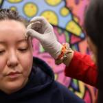 Clarise Larson / Juneau Empire
Soleil Lambert, a piercer from San Antonio, prepares Juneau resident Sydney Johnson for an eyebrow piercing Thursday afternoon at Elizabeth Peratrovich Hall during the Ink Masters Tattoo Show.
