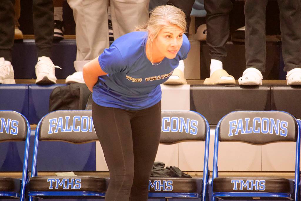 Thunder Mountain High School volleyball coach Julie Herman offers guidance to her team during their three-game home-court match against Juneau-Douglas High School: Yadaa.at Kalé on Friday night. (Mark Sabbatini / Juneau Empire)