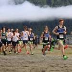 High school boys sprint after the starting gun fires on Saturday morning during the Sayeik Invitational on Douglas. (Clarise Larson / Juneau Empire)