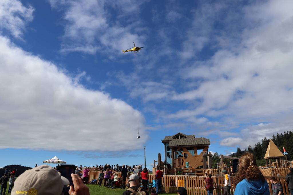 A helicopter lifts a net carrying 5,769 rubber ducks at Twin Lakes Park during the Glacier Valley Rotary Duck Derby on Saturday. (Meredith Jordan / Juneau Empire)