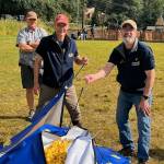 Max Mertz, Dan Holt and Eric Forst prepare to seal a net with 5,769 rubber ducks for their drop over Twin Lakes on Saturday during the Glacier Valley Rotary Duck Derby. (Photo by Kelly Moore)