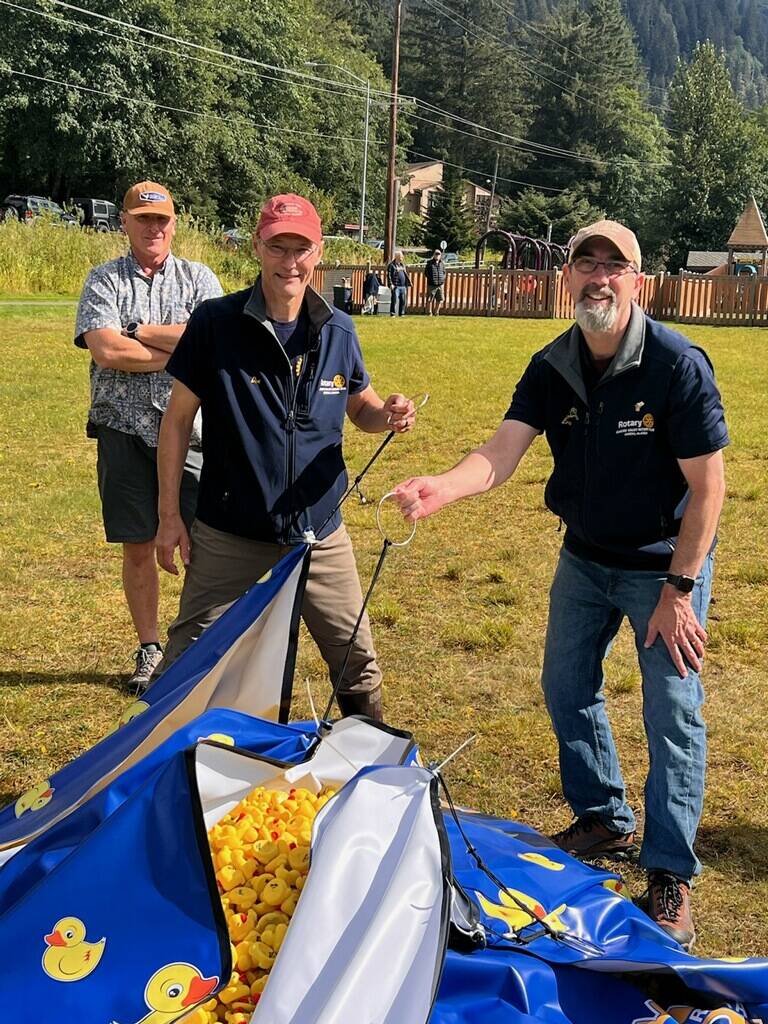Max Mertz, Dan Holt and Eric Forst prepare to seal a net with 5,769 rubber ducks for their drop over Twin Lakes on Saturday during the Glacier Valley Rotary Duck Derby. (Photo by Kelly Moore)
