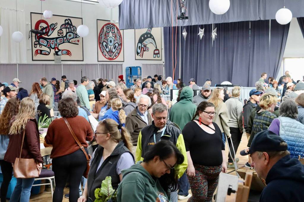 Hundreds of people examine crafts and other items at the Annual Food Festival & Farmers Market on Saturday. (Meredith Jordan / Juneau Empire)