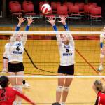 Thunder Mountain High Schools Jenna Dobson (4) and Ashlyn Gates (5) try to deflect the ball back to the Juneau-Douglas High School: Yadaa.at Kalé side during a matchup between the two local teams Saturday at JDHS. (Mark Sabbatini / Juneau Empire)