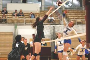 Ketchikan High Schools Bella Westfall-Zink attempts to block Thunder Mountain High Schools Ashlyn Gates during Fridays match in Ketchikan, which Thunder Mountain won 3-0. TMHS also swept Ketchikan 3-0 on Saturday night. (Christopher Mullen / Ketchikan Daily News)