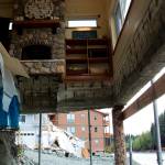The living room of Marty and Marjorie McKeowns house remains exposed a month after record flooding of the Mendenhall River eroded the couples backyard and portions of the earth under their home. In the backdrop next door are the remains of a home that mostly collapsed into the river during the flood and a condominium that is being propped up with posts and rock fill in an attempt to make it safe to occupy again. (Mark Sabbatini / Juneau Empire)