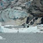 A sediment-laden grey waterfall gushes jokulhlaup water from under Mendenhall Glacier at 9:30 p.m. on July 20, 2011. (Photo by Laurie Craig)