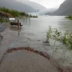 A thick flotsam line of twigs and branches flow onto the Photo Point Trail footbridge during the July 11, 2014 outburst flood. High water was 11.85 feet. Normal lake level is 5.5 feet. (Photo by Laurie Craig)