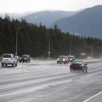 Cars pass down Egan Drive near the Fred Meyer intersection Thursday morning. (Clarise Larson / Juneau Empire)