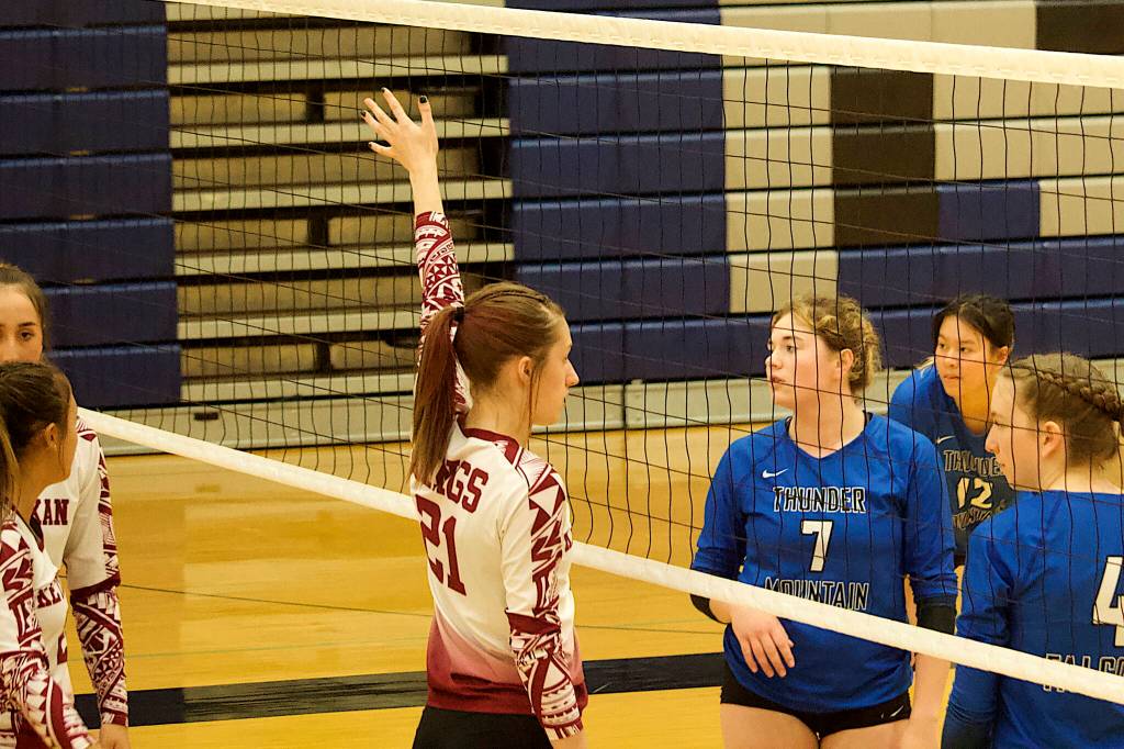 Players for Thunder Mountain High School and Ketchikan High School face off at the net during their five-set game Saturday at TMHS. (Mark Sabbatini / Juneau Empire)