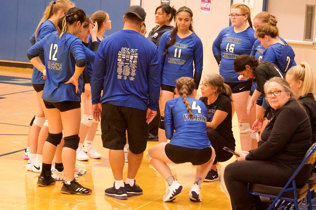 Thunder Mountain High School coach Julie Herman huddles with her players during a timeout in the teams five-game set against Ketchikan High School on Saturday night at TMHS. (Mark Sabbatini / Juneau Empire)