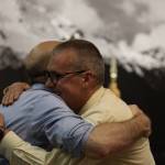 City and Borough of Juneau Deputy City Manager Robert Barr (left) and retiring City Manager Rorie Watt (right) hug Monday night during an Assembly meeting where Watt was honored for his time as manager. (Clarise Larson / Juneau Empire)