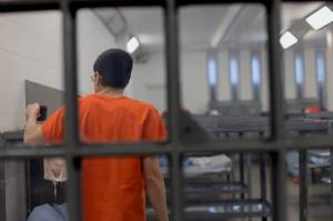 An inmate stands near a bunk at Lemon Creek Correctional Center on Monday. The prison is at about 45% capacity as it is currently undergoing structural repairs and renovations following extreme wet weather last fall that caused instability at certain locations and prompted emergency repairs. (Clarise Larson / Juneau Empire)
