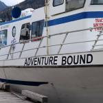 The Adventure Bound tour boat is seen here docked at Aurora Harbor in July. The vessels owner-operator was given four notices of deficiencies last year, but continued to operate, according to a U.S. Coast Guard report that also raises questions about the agencys handling of a grounding incident involving the company. (Meredith Jordan / Juneau Empire File)