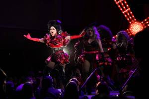 Longtime Juneau drag pillar Gigi Monroe leads a dance alongside other performers during the eighth annual GLITZ drag show at the Centennial Hall ballroom Saturday night. (Clarise Larson / Juneau Empire)