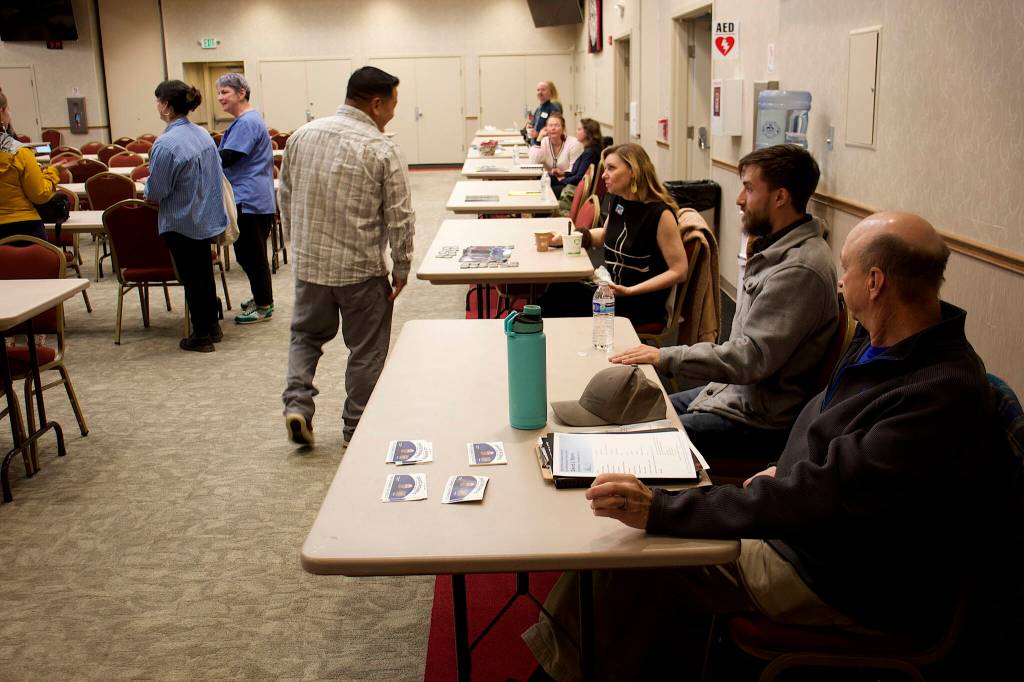 Juneau Assembly candidate talk to prospective voters at Elizabeth Peratrovich Hall before Friday nights forum hosted by The Central Council of the Tlingit and Haida Indian Tribes of Alaska. (Mark Sabbatini / Juneau Empire)