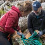 Zofia Danielson, marine debris coordinator with Sitka Sound Science Center, works alongside Michael LaVine, senior director of Alaska programs with Ocean Conservancy, to portion up a large piece of trawl net to be carried back to the pickup site. (Ryan Morse / Sitka Conservation Society)
