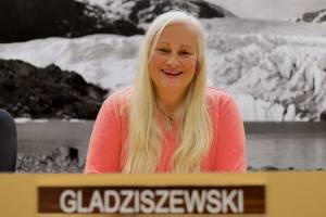 Soon-departing Assembly member and Deputy Mayor Maria Gladziszewski smiles for a photo at her seat in the Assembly chambers Thursday afternoon. (Clarise Larson / Juneau Empire)