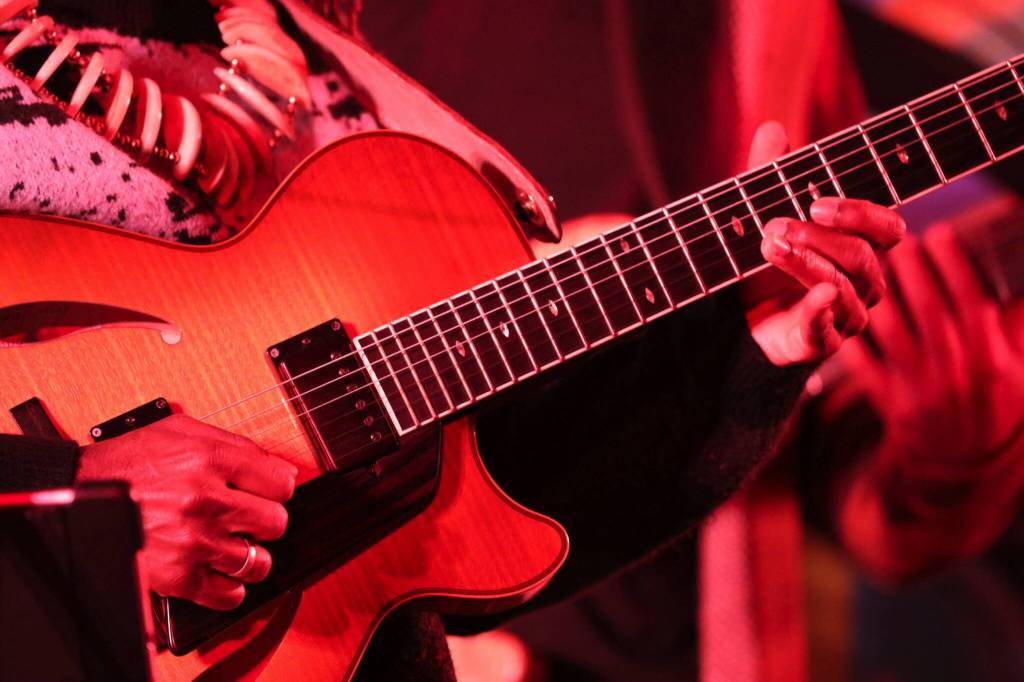 Albino Mbie, a musician from Mozambique, plays a solo on his guitar during a performance Thursday night as part of the Áakw Rock music festival at Elizabeth Peratrovich Hall. (Clarise Larson / Juneau Empire)