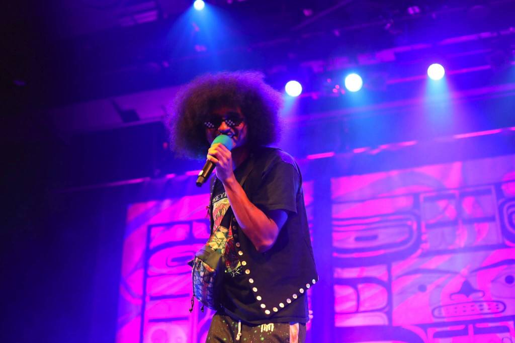 AirJazz, a Tlingit hip-hop artist from Juneau, raps to the crowd during a performance Thursday night as part of the Áakw Rock music festival at Centennial Hall. (Clarise Larson / Juneau Empire)