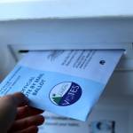 A 2023 municipal election ballot is placed in the drop box at Douglas Library/Fire Hall Community Building. (Clarise Larson / Juneau Empire File)