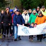 Officials, volunteers and donors affiliated with St. Vincent de Paul Juneau walk down a path alongside Egan Drive on Saturday morning as part of a Friends of the Poor Run/Walk to raise money for the facility and its programs. (Mark Sabbatini / Juneau Empire)