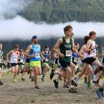High school boys sprint after the starting gun fires during the Sayeik Invitational on Douglas on Aug. 26. Students from Southeast Alaska schools are scheduled to meet at the same site Saturday for the Region V cross-country champions. (Clarise Larson / Juneau Empire File)