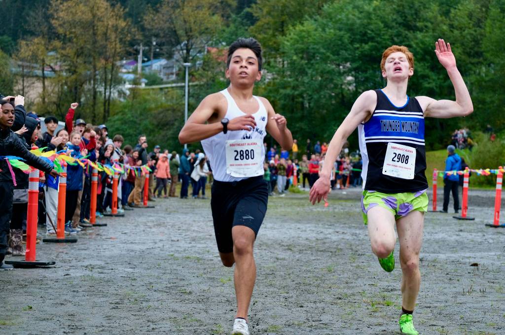 Juneau-Douglas High School: Yadaa.at Kalé senior Edgar Vera Alverado, left, holds off Thunder Mountain freshman Erik Thompson to win the Region V Division I Boys Cross Country Championship on Saturday at Treadwell Mine Trails. (Klas Stolpe / For the Juneau Empire)