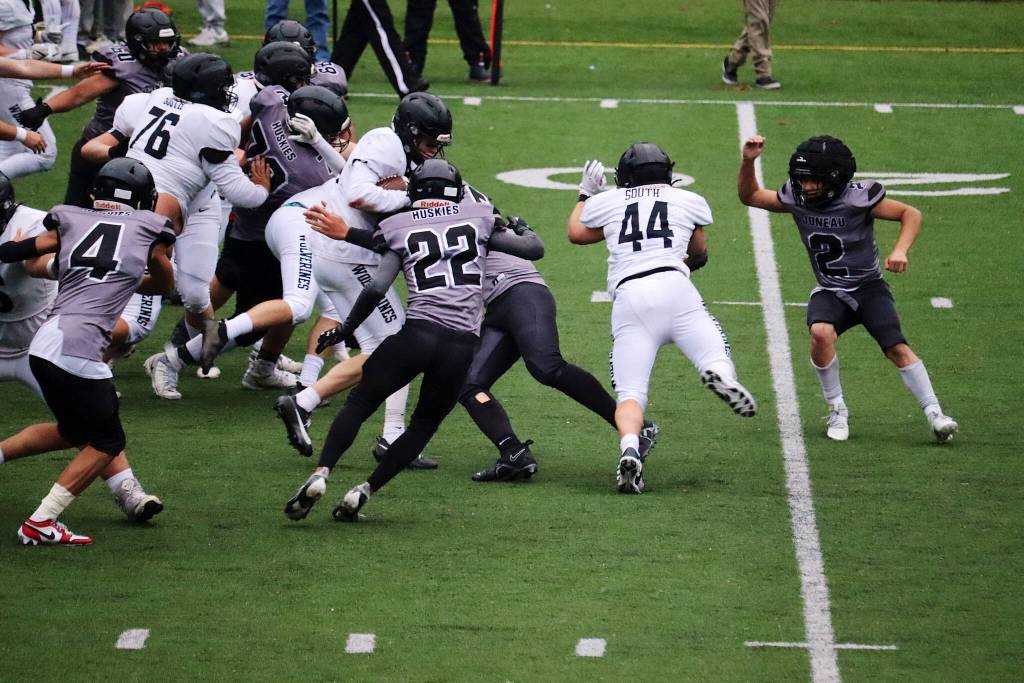 An Anchorage South High School ballcarrier is gang tackled by Juneaus defense during Saturdays game at Adair-Kennedy Field. (Mark Sabbatini / Juneau Empire)