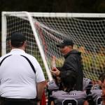 Juneau Huskies coach Rich Sjoroos talks to his players following Saturdays 46-0 loss against Anchorage South High School on Saturday at Adair-Kennedy Field. (Mark Sabbatini / Juneau Empire)