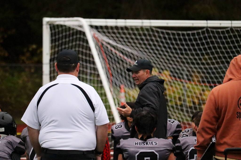 Juneau Huskies coach Rich Sjoroos talks to his players following Saturdays 46-0 loss against Anchorage South High School on Saturday at Adair-Kennedy Field. (Mark Sabbatini / Juneau Empire)