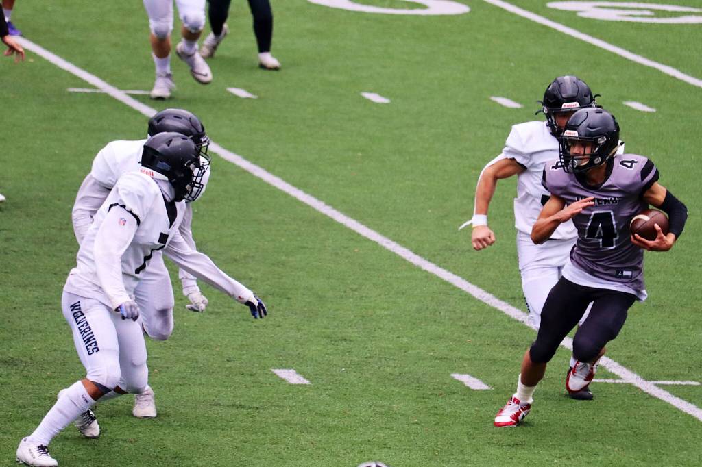 Juneaus Jayden Johnson (4) looks for room to run against Anchorage South High School during Saturdays game at Adair-Kennedy Field. Johnson, a junior, was one of the Huskies top offensive and defensive playmakers during the regular season. (Mark Sabbatini / Juneau Empire)
