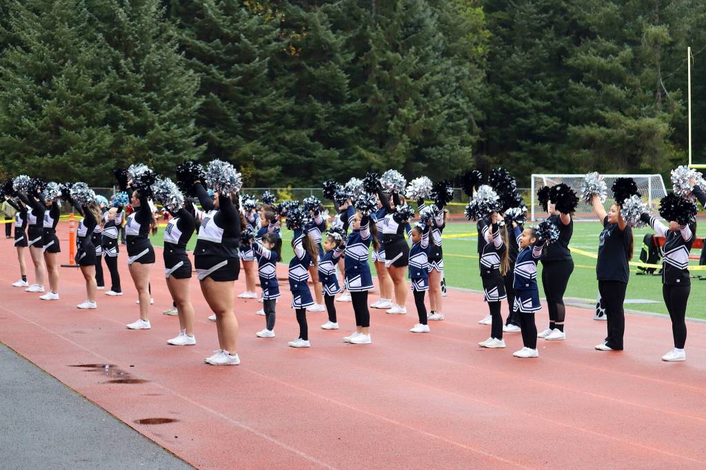 An expanded squad of cheerleaders urges the crowd on just before halftime of the Juneau Huskiess final home game of the season Saturday at Adair-Kennedy Field. (Mark Sabbatini / Juneau Empire)