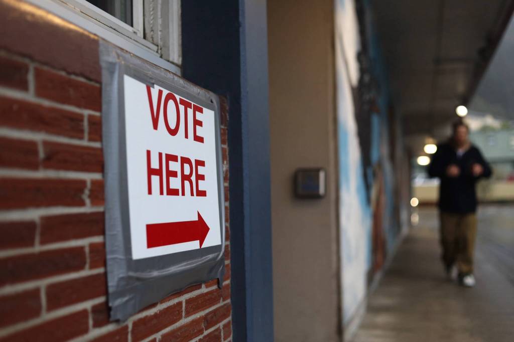 A man heads to the City Hall Assembly Chambers to cast his ballot on Election Day Tuesday. (Clarise Larson / Juneau Empire)
