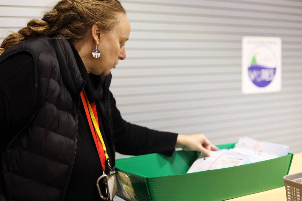 City and Borough of Juneau Deputy Clerk Diane Cathcart prepares ballots at the CBJ ballot processing center on Election Day Tuesday morning. (Clarise Larson / Juneau Empire)