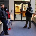 Evan Wood (left), Yvette Fountain (middle) and Nasir Spears wait outside the Alaska Department of Revenue office in the State Office Building on Thursday morning to discuss issues related to their Permanent Fund dividends. A majority of state residents got $1,312 dividends electronically deposited Thursday  or a day or two earlier  a considerably lower dividend than the $3,284 payout last year. (Mark Sabbatini / Juneau Empire)