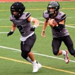 Jayden Johnson (4) and Hayden Aube (2), seen here against Dimond High School on Aug. 19, were the biggest offensive playmakers for the Juneau Huskies this season and were used according during the teams opening playoff game at Anchorage West High School on Friday night. The Huskies, seeded last in the eight-team conference, took an early lead and battled on even terms with top-ranked Anchorage for most of the first half before losing 48-7. (Mark Sabbatini / Juneau Empire)