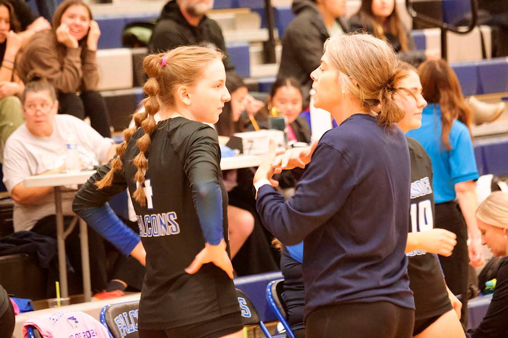 Thunder Mountain High School volleyball coach Julie Herman confers with Jenna Dobson during a timeout in Saturdays game against Mt. Edgecumbe High School at TMHS. (Mark Sabbatini / Juneau Empire)