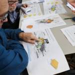 Tony Tengs points to his previous home while looking at the new design concepts for the Telephone Hill redevelopment project that were presented Wednesday evening at the Juneau Arts and Culture Center. (Clarise Larson / Juneau Empire)