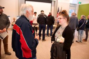 Jerry Millsaps, who is visually impaired, and Autumn Booths, who teaches local students who are visually impaired, discuss a proposed new roundabout on Mendenhall Loop Road near Millsaps house during at open house about the project Wednesday evening at the Mendenhall Valley Public Library. Millsaps said he is concerned because he cannot safely cross the street where two other roundabouts already exist, and the new one will create the same problem unless a pedestrian signal with audio and visual cues is installed. (Mark Sabbatini / Juneau Empire)