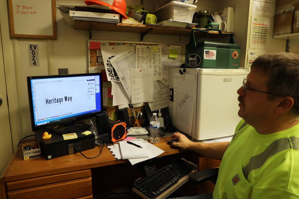 Chris Anderson touches up the design for the new Heritage Way signs in the making ahead of the South Seward Street name change Nov. 1. (Clarise Larson / Juneau Empire)